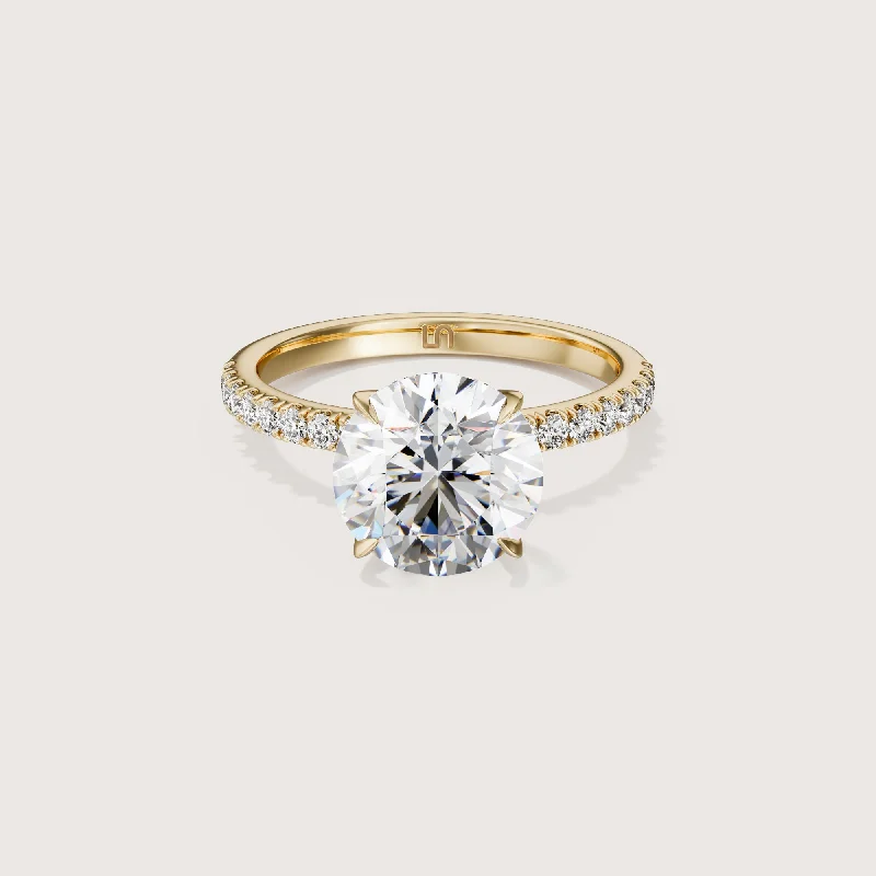 Radiant - cut diamond engagement ring with a bezel - set center stone in 18K yellow goldIcon Round Solitaire - 4 claw - Diamond Band