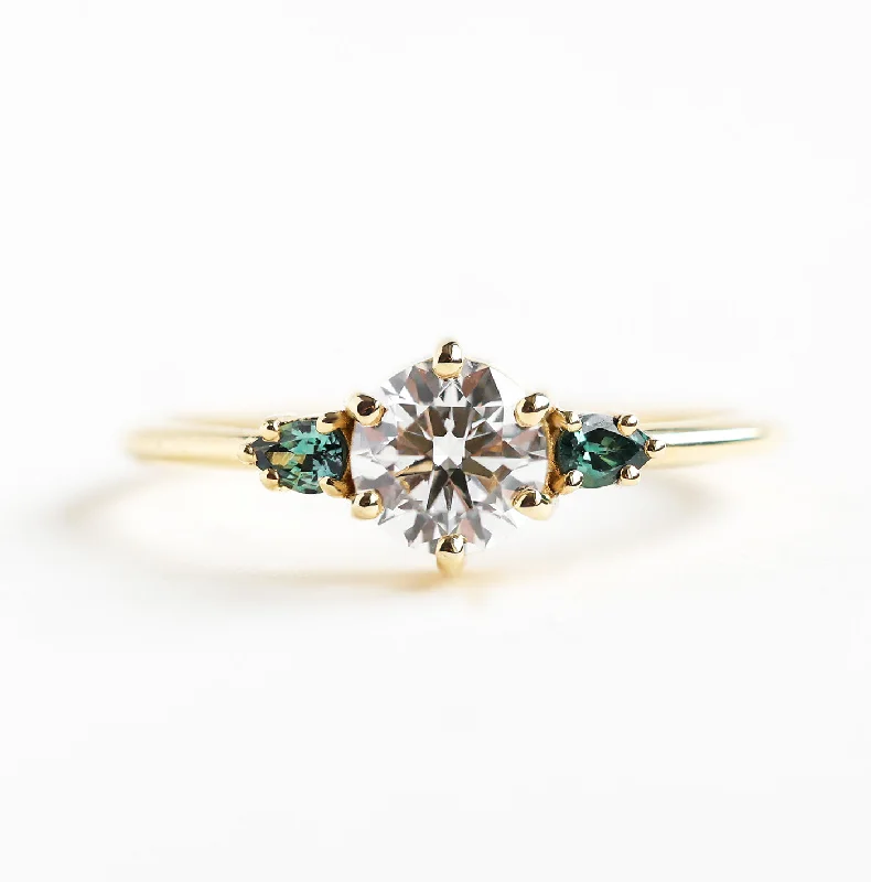 Art Deco - Inspired Women's Diamond Rings with Geometric Designs and Baguette - Cut DiamondsRound Three Stone Diamond Ring With Teal Pear Sapphires