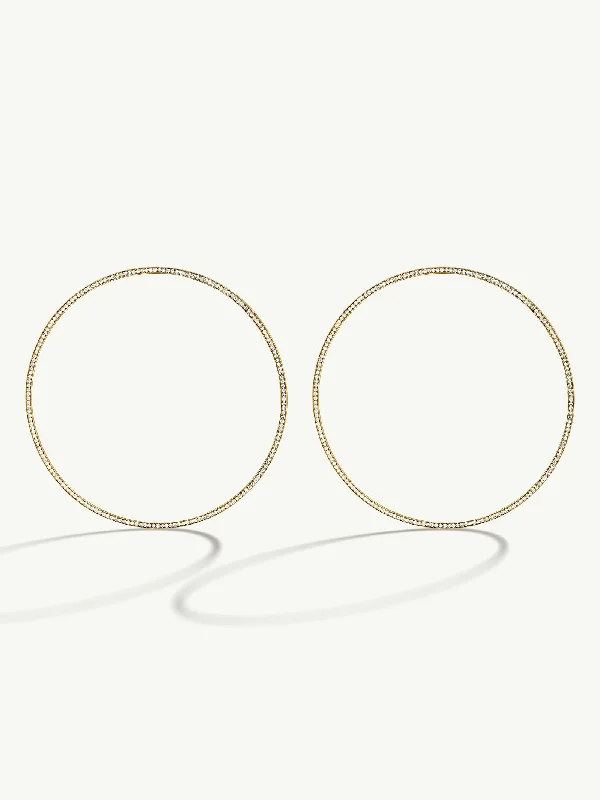 Round - cut diamond engagement ring with a twisted band design in 14K white goldAura Pavé-Set Brilliant White Diamond Eternity Hoop Earrings In 18K Yellow Gold