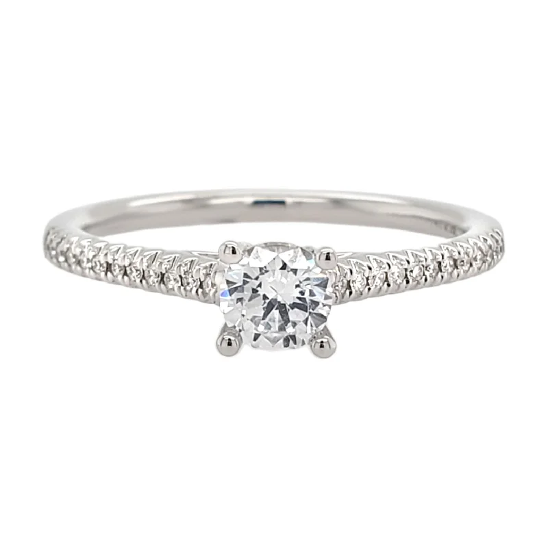 Solitaire diamond engagement ring with a platinum setting for a classic and elegant look4-Prong Cathedral Style Diamond Engagement Ring Setting with Pave Band