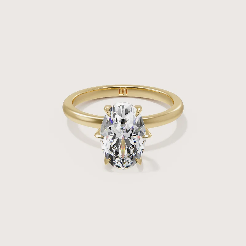 Three - stone diamond engagement ring in rose gold, symbolizing past, present, and futureIcon Oval Solitaire - 6 Claw