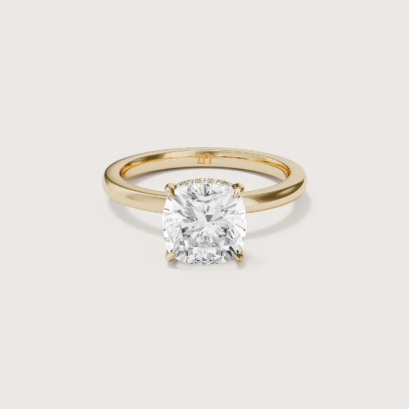 Three - stone diamond engagement ring in rose gold, symbolizing past, present, and futureBianca Cushion Solitaire - Hidden Halo